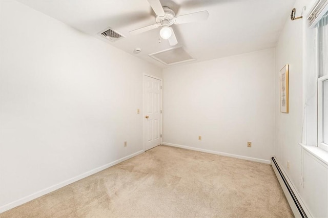 carpeted spare room with a baseboard radiator and ceiling fan