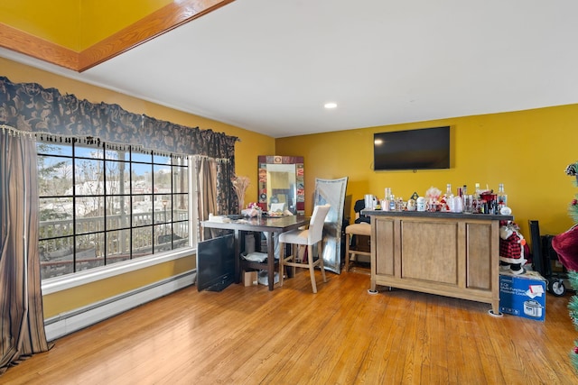 interior space featuring a baseboard radiator, wood finished floors, and recessed lighting