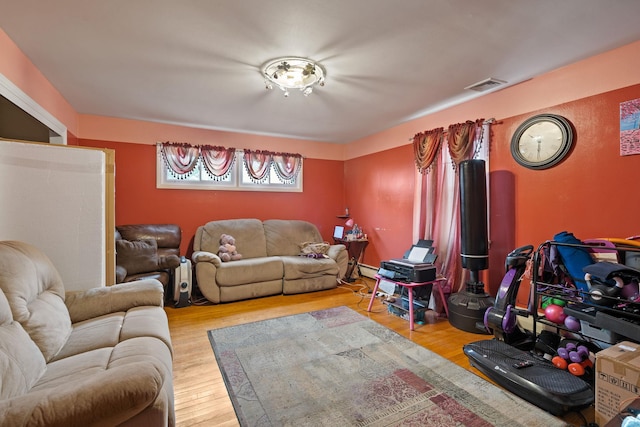 living area featuring wood finished floors and visible vents