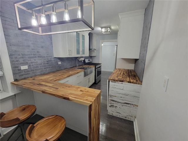 245BRONXRIVERRD Bronx River Rd Unit 3E, Yonkers, NY 10704 - kitchen featuring butcher block counters, stainless steel gas range, glass insert cabinets, white cabinetry, and dark wood-type flooring