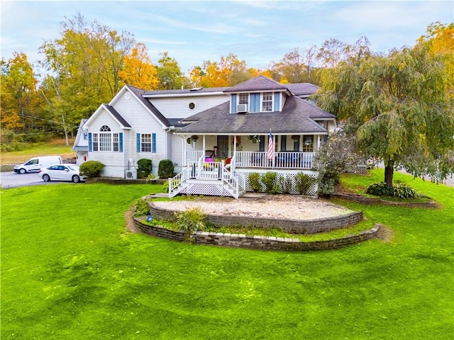 rear view of property with covered porch and a yard