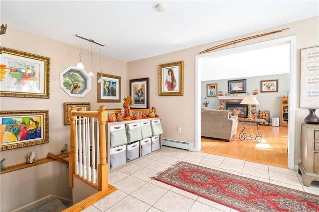 entryway featuring a fireplace, light hardwood / wood-style floors, and baseboard heating