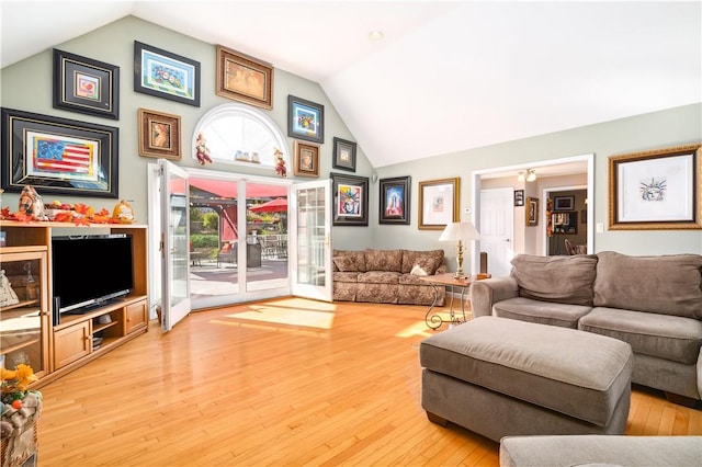 living room with hardwood / wood-style floors and lofted ceiling