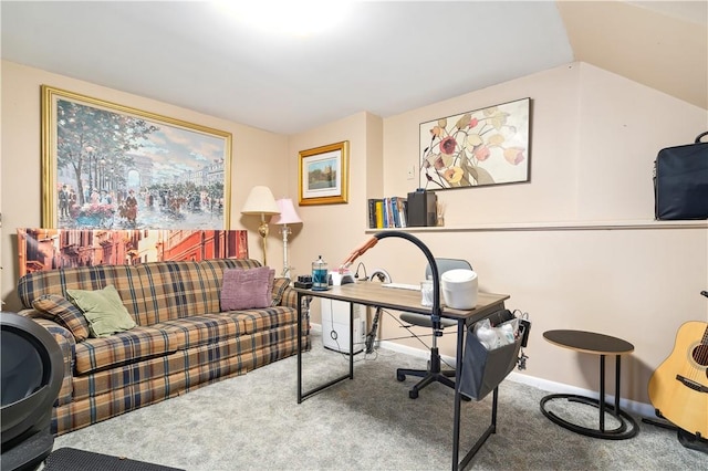 carpeted home office with vaulted ceiling