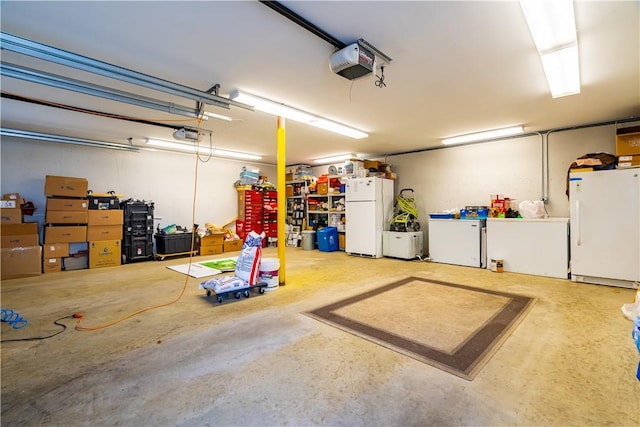 garage featuring white refrigerator and a garage door opener