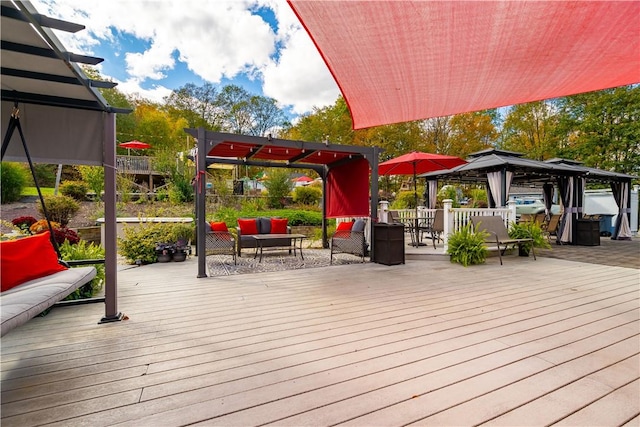 wooden terrace with a gazebo and an outdoor hangout area