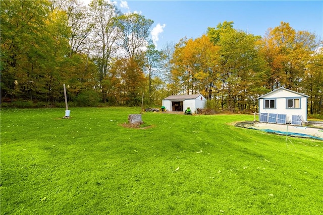 view of yard featuring an outbuilding and a pool