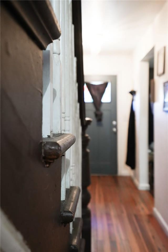 corridor with dark hardwood / wood-style flooring