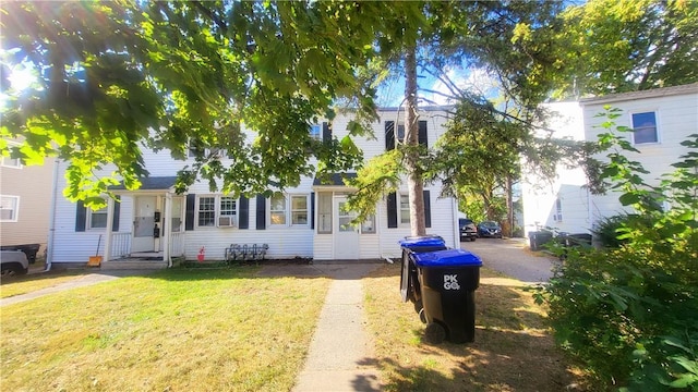 view of front of home with a front yard and cooling unit