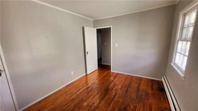 unfurnished room featuring a baseboard radiator, crown molding, a wealth of natural light, and dark wood-type flooring