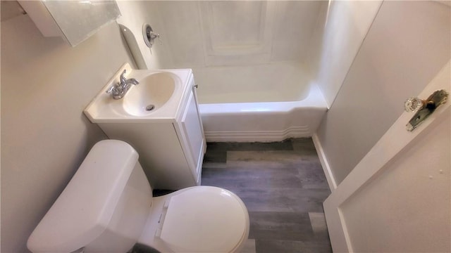 bathroom with hardwood / wood-style floors, vanity, and toilet