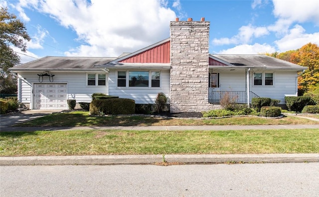 view of front of home with a front yard and a garage