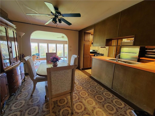 dining room with ceiling fan and sink