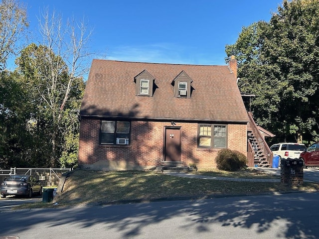 cape cod house featuring cooling unit