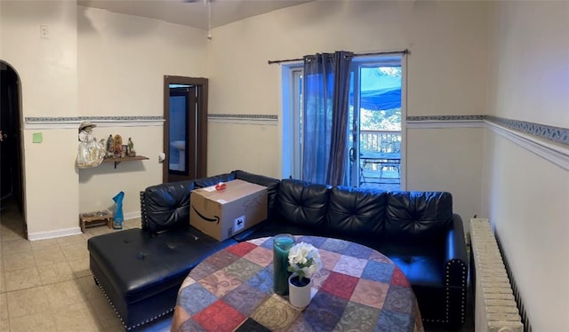 living room with radiator heating unit and light tile patterned floors