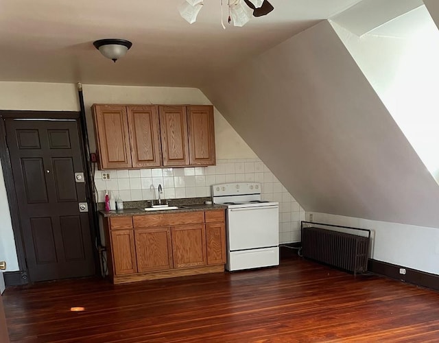 kitchen with dark hardwood / wood-style flooring, stove, radiator heating unit, and vaulted ceiling