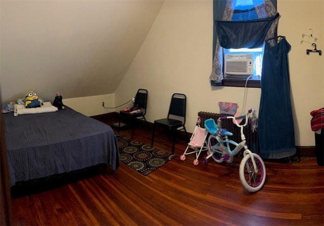 bedroom featuring cooling unit, wood-type flooring, and lofted ceiling