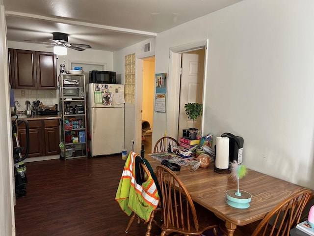 dining area with dark hardwood / wood-style floors and ceiling fan