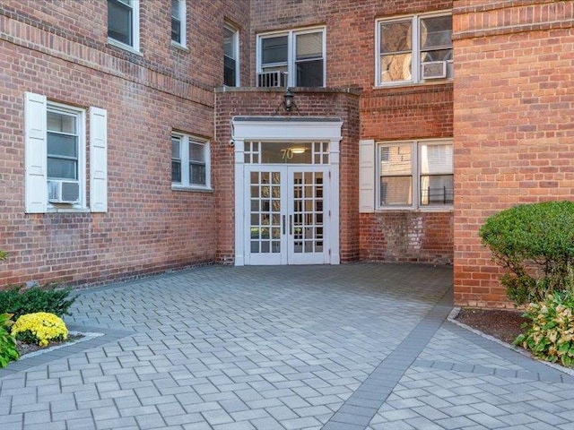 doorway to property with french doors, a patio, and cooling unit