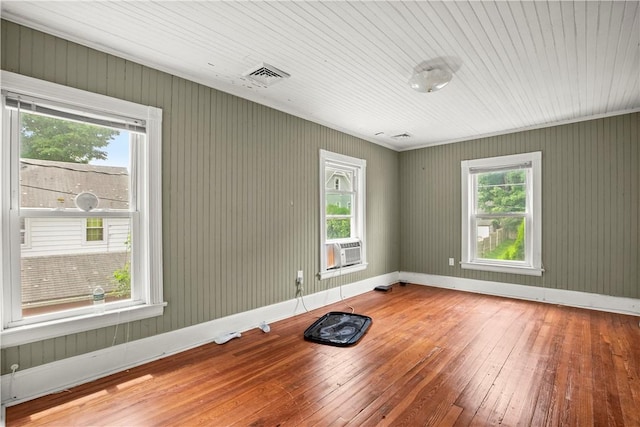 unfurnished room with wooden ceiling, hardwood / wood-style floors, cooling unit, and a healthy amount of sunlight