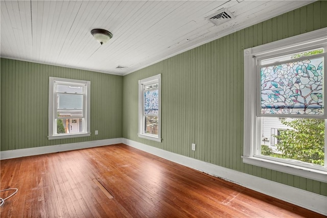 unfurnished room featuring a wealth of natural light, wood-type flooring, and wooden ceiling