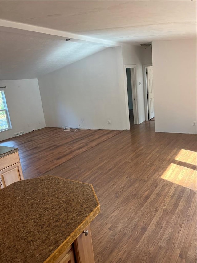 unfurnished living room with dark hardwood / wood-style flooring and vaulted ceiling