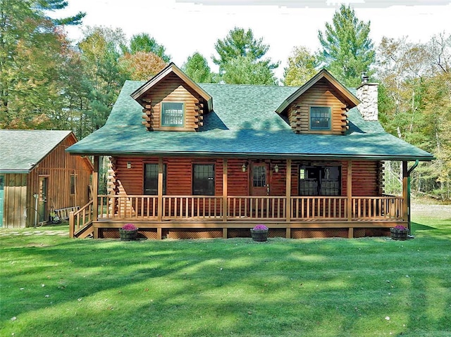 back of property with a lawn and covered porch