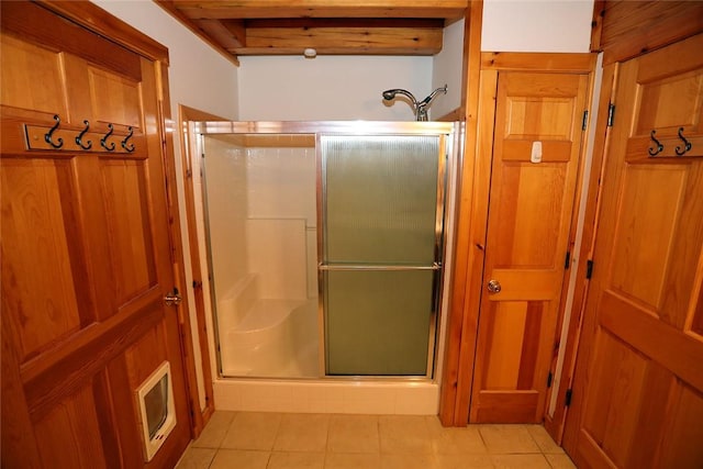 bathroom with tile patterned flooring and a shower with shower door