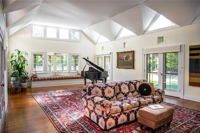 living room featuring french doors, dark hardwood / wood-style flooring, and high vaulted ceiling