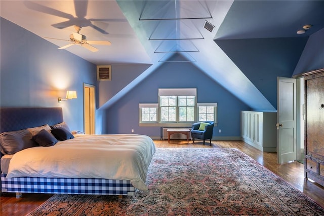 bedroom with hardwood / wood-style flooring, ceiling fan, lofted ceiling, and radiator heating unit