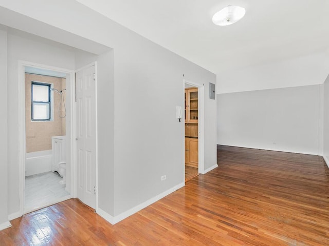 unfurnished room with hardwood / wood-style floors