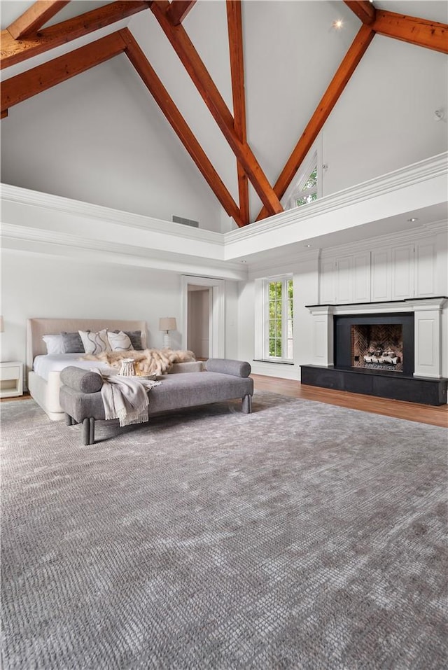 unfurnished bedroom featuring beam ceiling, carpet floors, and high vaulted ceiling