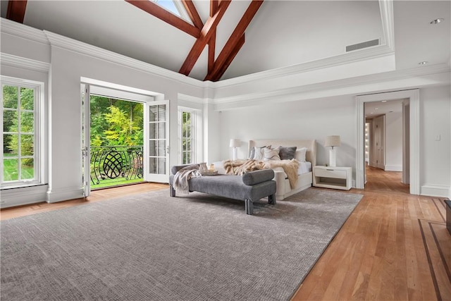 bedroom with access to exterior, light hardwood / wood-style flooring, high vaulted ceiling, and multiple windows