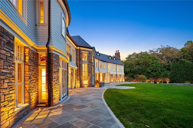 exterior space featuring a lawn and a patio area