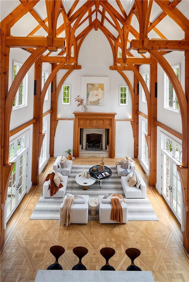 living room featuring a towering ceiling and french doors