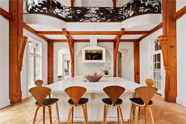 dining space with light parquet flooring and a high ceiling