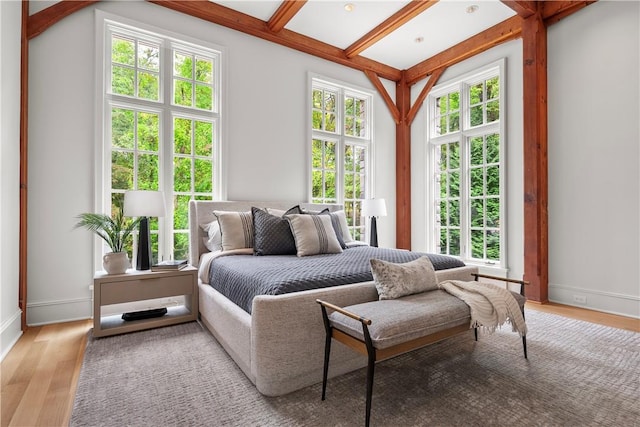 bedroom with light hardwood / wood-style floors and multiple windows