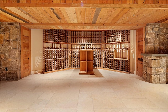 wine room with beamed ceiling and wood ceiling