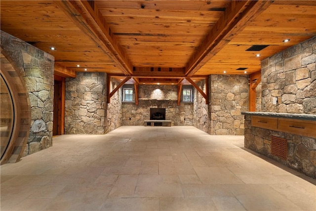 interior space featuring a fireplace, beam ceiling, and wooden ceiling