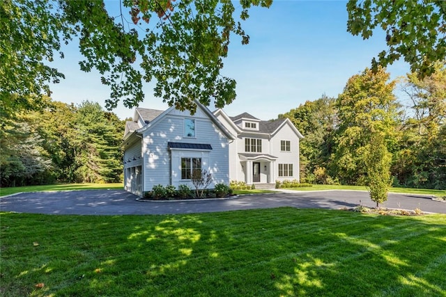 view of front of property with a garage and a front yard