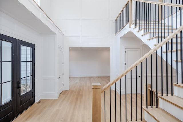 foyer with french doors and wood-type flooring