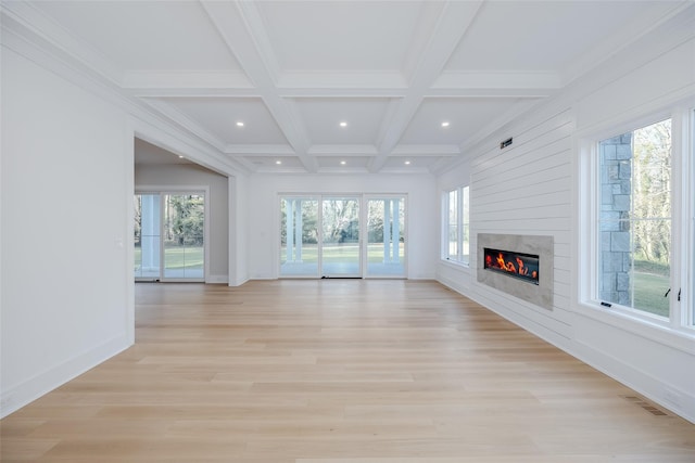 unfurnished living room with beam ceiling, crown molding, coffered ceiling, and light hardwood / wood-style flooring