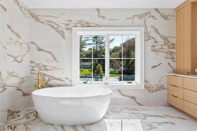 bathroom with a bathtub and vanity