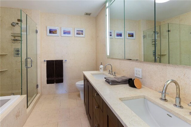 640 W 237th St Unit 12B, Bronx, NY 10463 - full bathroom with tile patterned floors, toilet, tile walls, and independent shower and bath