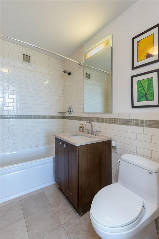 640 W 237th St Unit 12B, Bronx, NY 10463 - full bathroom with vanity, tile patterned floors, tiled shower / bath combo, toilet, and tile walls