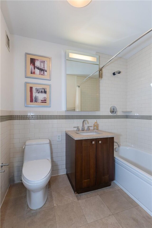 640 W 237th St Unit 12B, Bronx, NY 10463 - full bathroom with toilet, vanity, tile patterned floors, and tile walls