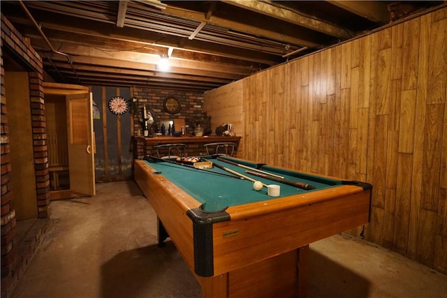 recreation room with concrete flooring, wooden walls, and billiards