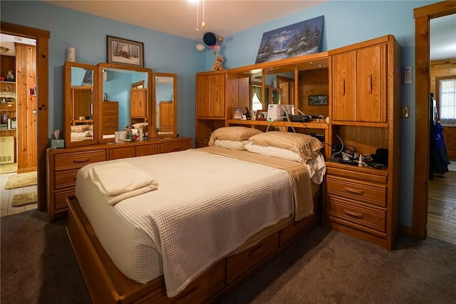 bedroom featuring dark carpet