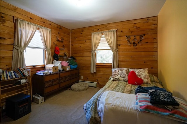 bedroom with wooden walls, carpet, and a baseboard heating unit