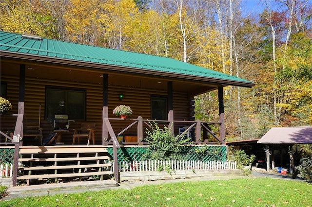 rear view of house featuring covered porch